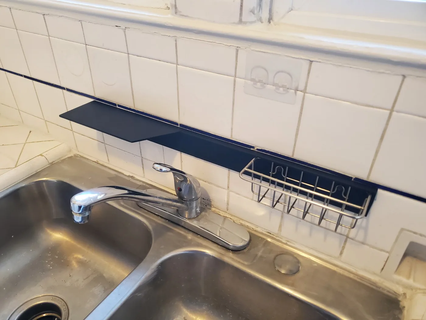 After: The same sink area with a new faucet and clean white tile backsplash