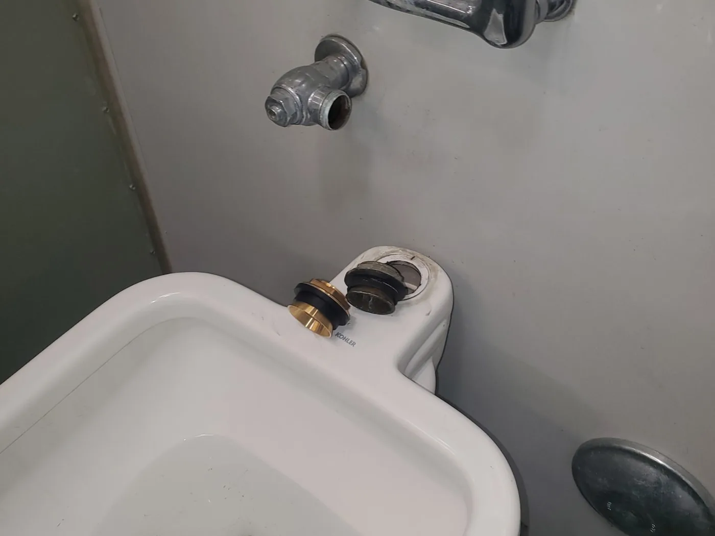 Before: Utility sink with corroded supply lines and no working fixture