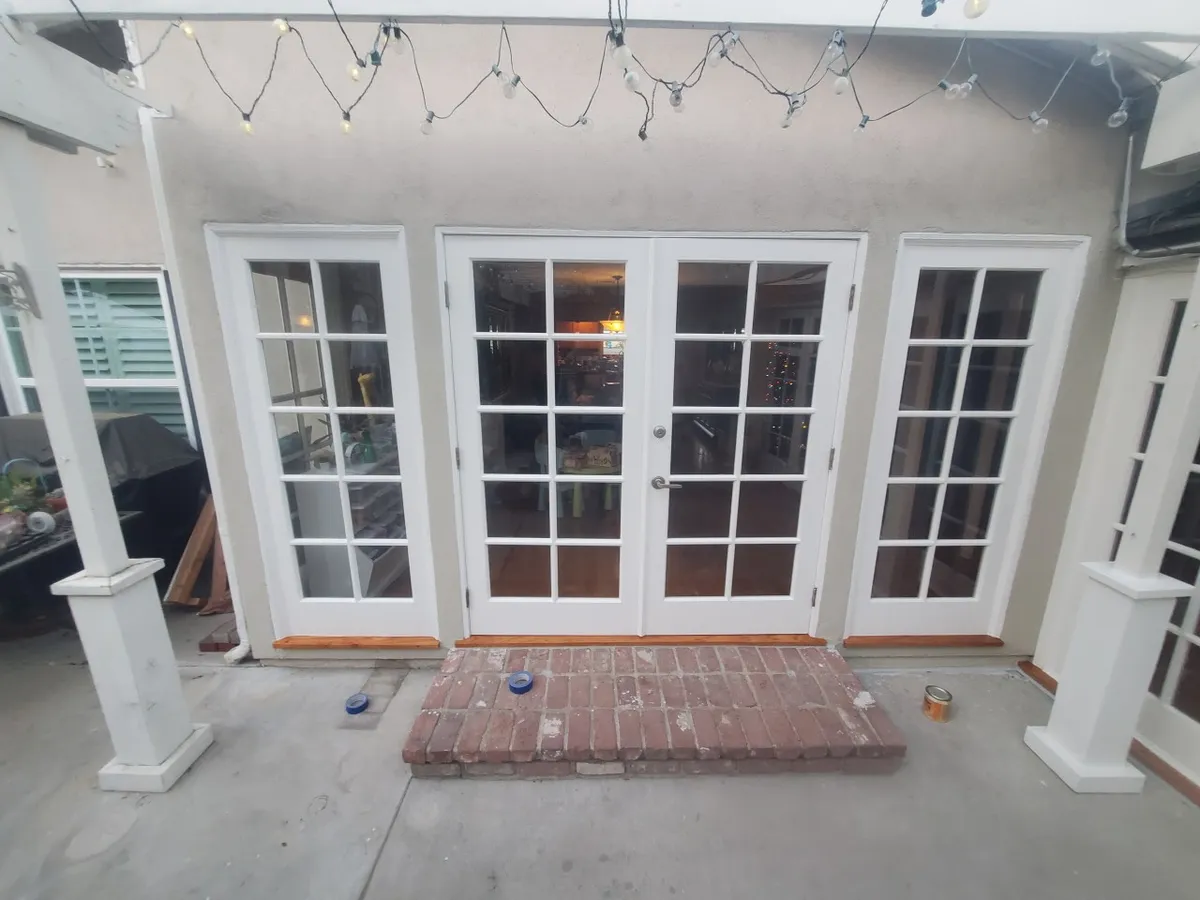 French doors and brick landing